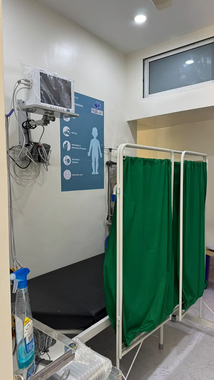 Treatment area with a patient bed, monitor, and privacy curtain