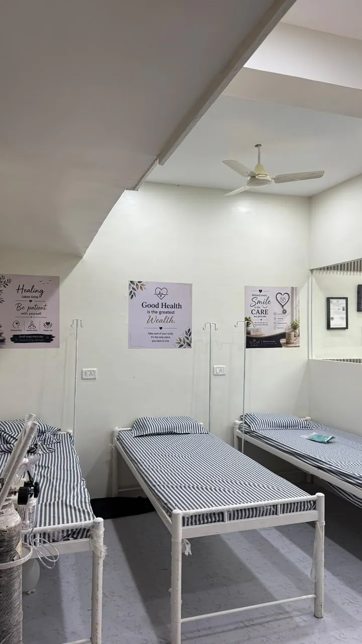 Several patient beds in a hospital room